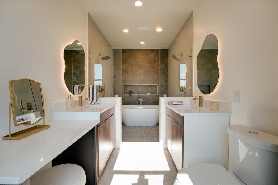 Bathrromwith dual vanities, backlit mirrors, freestanding tub