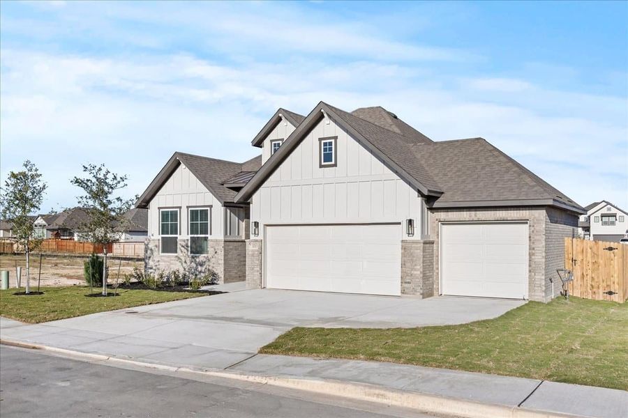 Front exterior of a new home in Village at Three Oaks, Seguin, TX, highlighting curb appeal (Image 20). Front exterior of a new home in Village at Three Oaks, Seguin, TX, highlighting curb appeal (Image 20).