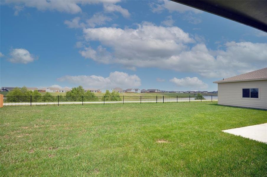 Expansive Rear Yard with a view tot he lake and a gate to the walking trail.