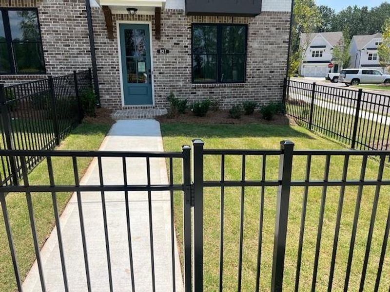 Front exterior of a new home in Palisades Townhomes, Cumming, GA, highlighting curb appeal (Image 1). Front exterior of a new home in Palisades Townhomes, Cumming, GA, highlighting curb appeal (Image 1).