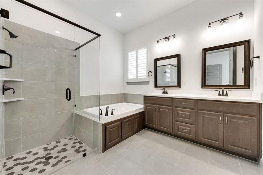 Bathroom with vanity, separate shower and tub, and tile patterned flooring