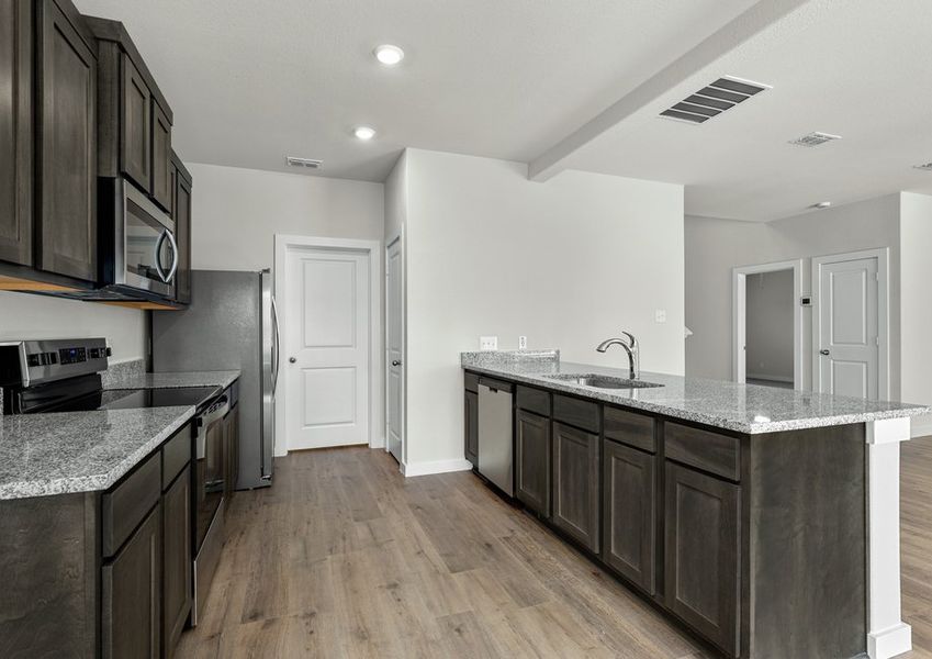The kitchen has beautiful wood cabinetry.