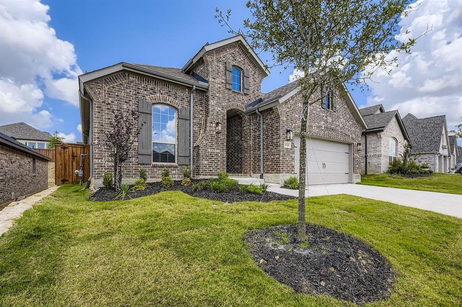 French country style house featuring driveway, brick siding, and a shingled roof French country style house featuring driveway, brick siding, and a shingled roof