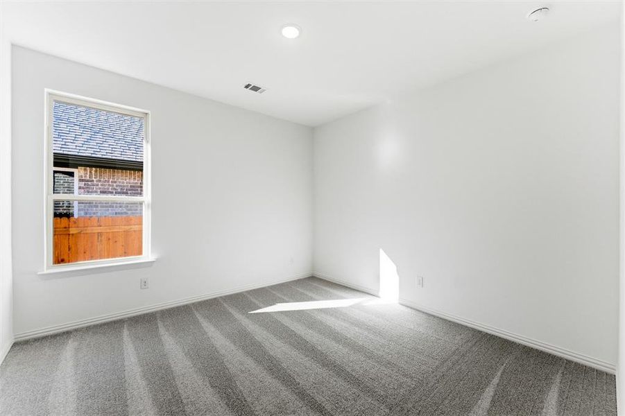 Carpeted empty room featuring baseboards and recessed lighting