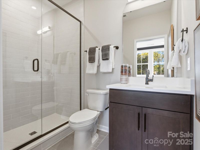 First Floor Full Bath with Walk-In Shower. *Model Photos | Actual Finishes, Structural Selections, and Orientation May Vary. First Floor Full Bath with Walk-In Shower. *Model Photos | Actual Finishes, Structural Selections, and Orientation May Vary.
