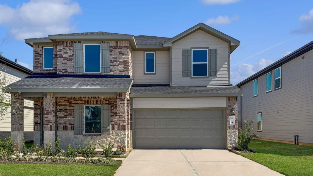 Front exterior of a new home in Tamarron, Fulshear, TX, highlighting curb appeal (Image 1).