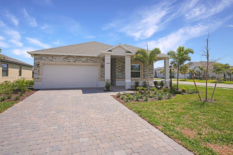 Front exterior of a new home in , Port Charlotte, FL, highlighting curb appeal (Image 14).