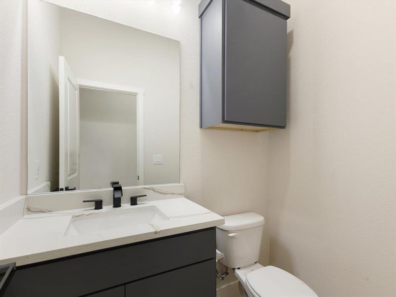 Bathroom featuring vanity and toilet