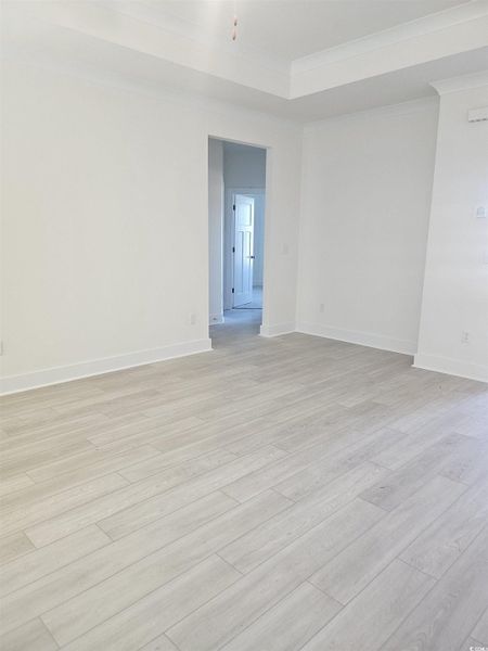 Empty room with light wood-style floors and ornamental molding Empty room with light wood-style floors and ornamental molding
