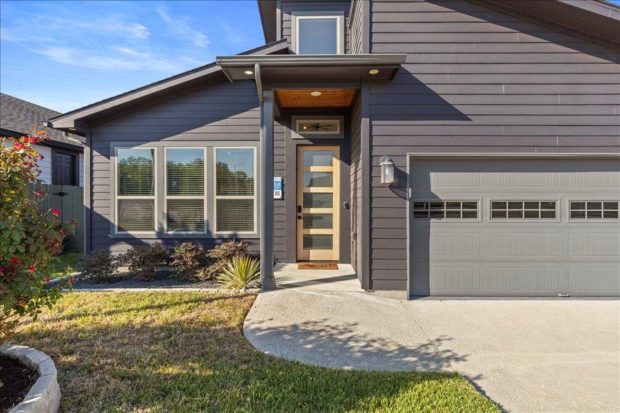 Doorway to property with a garage