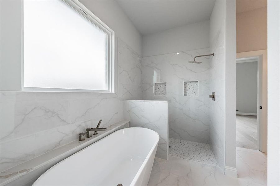 Enjoy relaxing in the free standing tub or the large walk in tiled shower