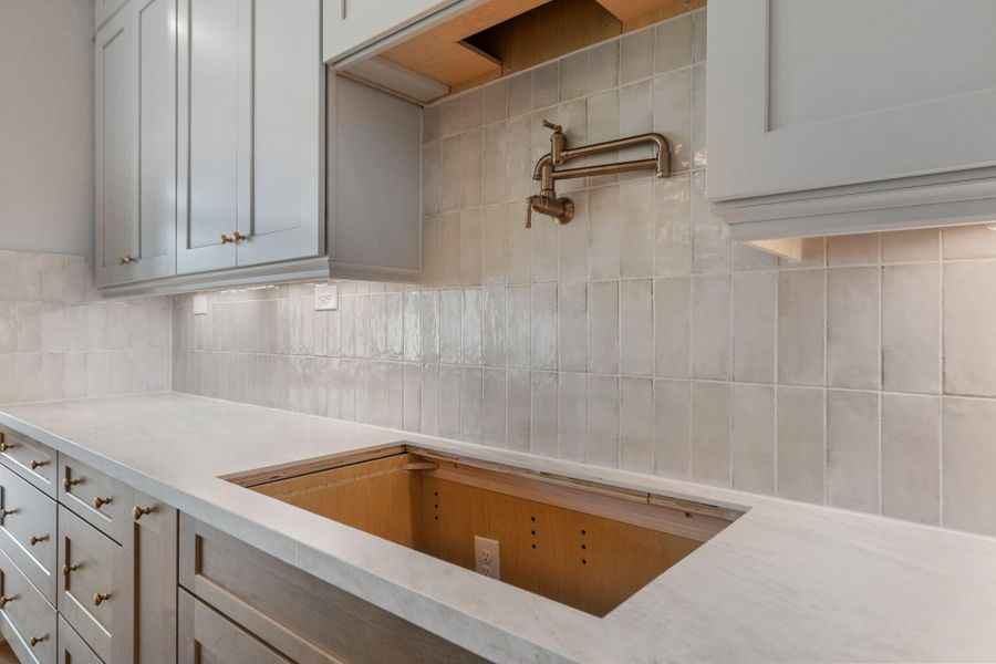 A pot filler is just one of the high-end details in the home