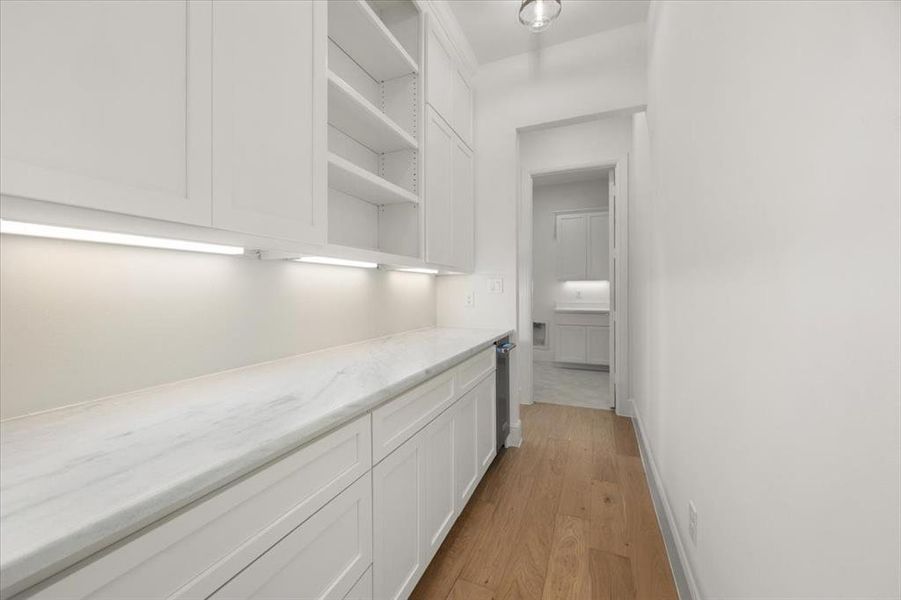 Butler's pantry or scullery hidden from kitchen; great for entertaining