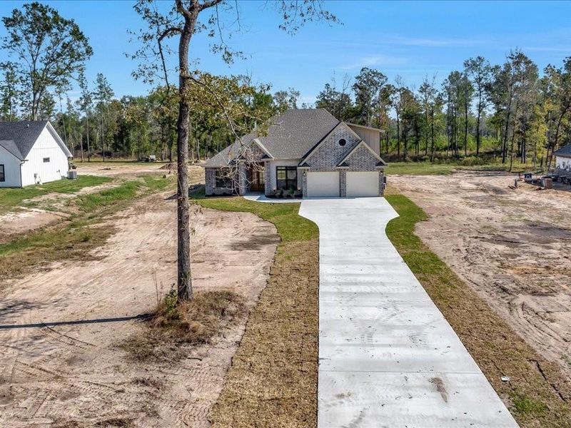 Front exterior of a new home in , Diboll, TX, highlighting curb appeal (Image 20). Front exterior of a new home in , Diboll, TX, highlighting curb appeal (Image 20).