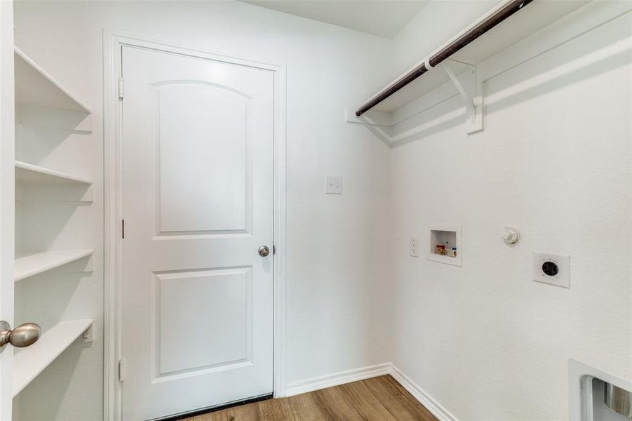 Washroom featuring hookup for a washing machine, gas dryer hookup, electric dryer hookup, and hardwood / wood-style floors