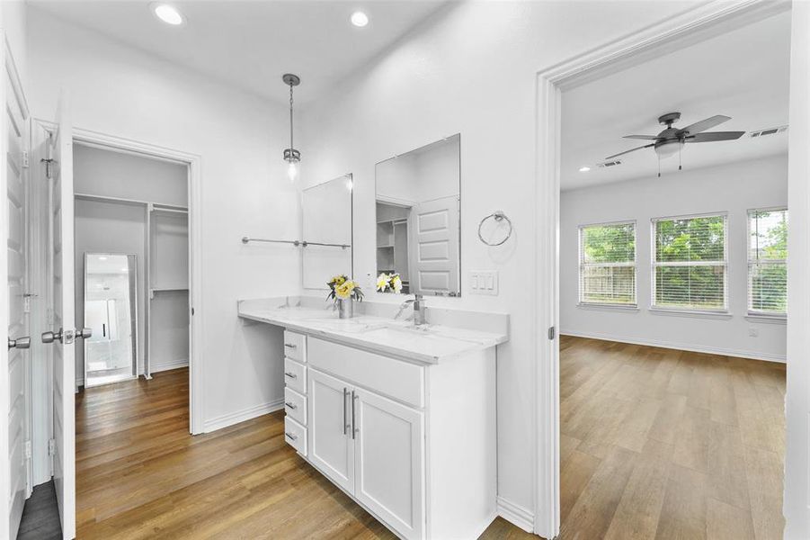 Double vanity with white cabinetry and integrated sinks