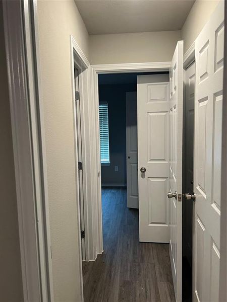 Hallway with dark wood-type flooring