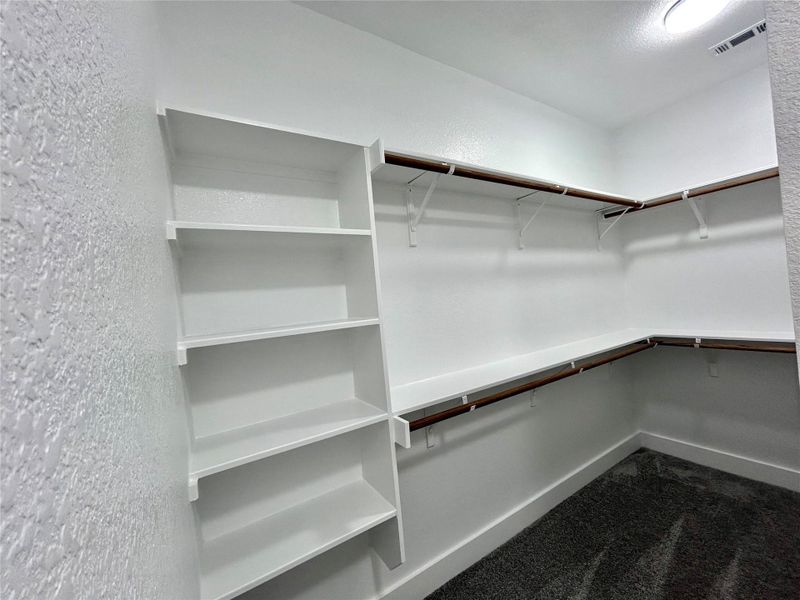 One side of the his and hers walk in closet. One side of the his and hers walk in closet.