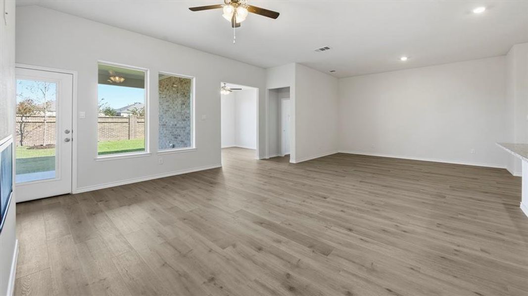 Unfurnished living room with light wood-style floors, a ceiling fan, and recessed lighting