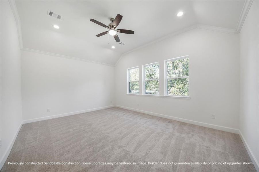 Primary Bedroom Retreat – Vaulted ceilings, plush carpeting, and natural light combine to create a peaceful and spacious haven.