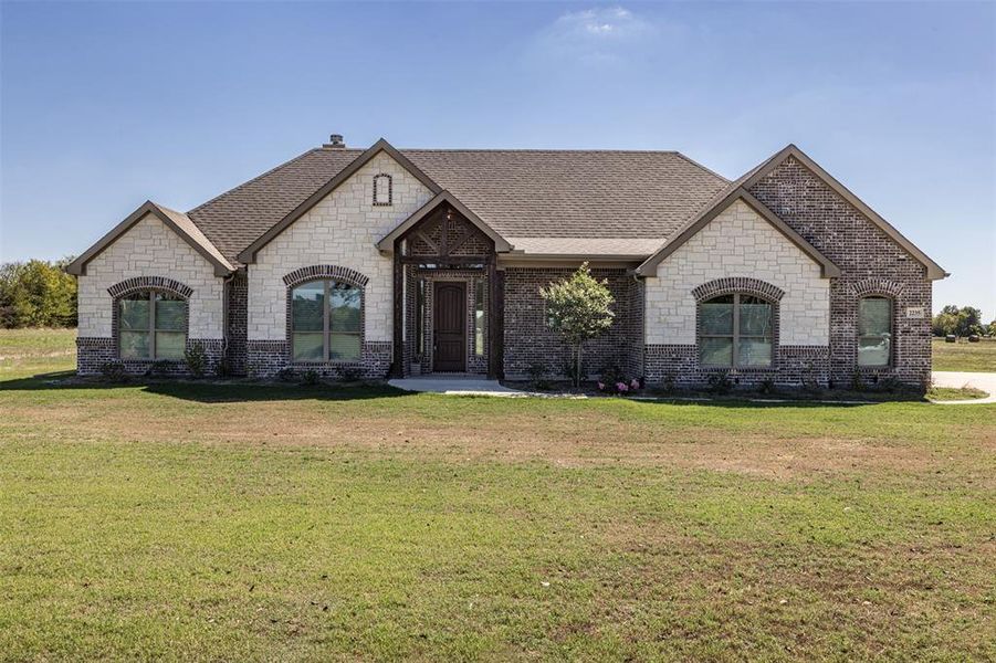 French country home with a front lawn