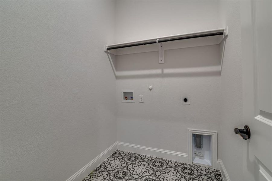 Clothes washing area featuring electric dryer hookup, gas dryer hookup, hookup for a washing machine, and light tile patterned floors