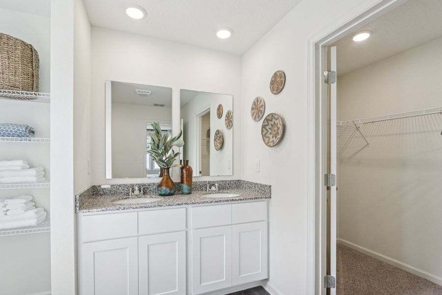 A bathroom with white cabinets. A bathroom with white cabinets.