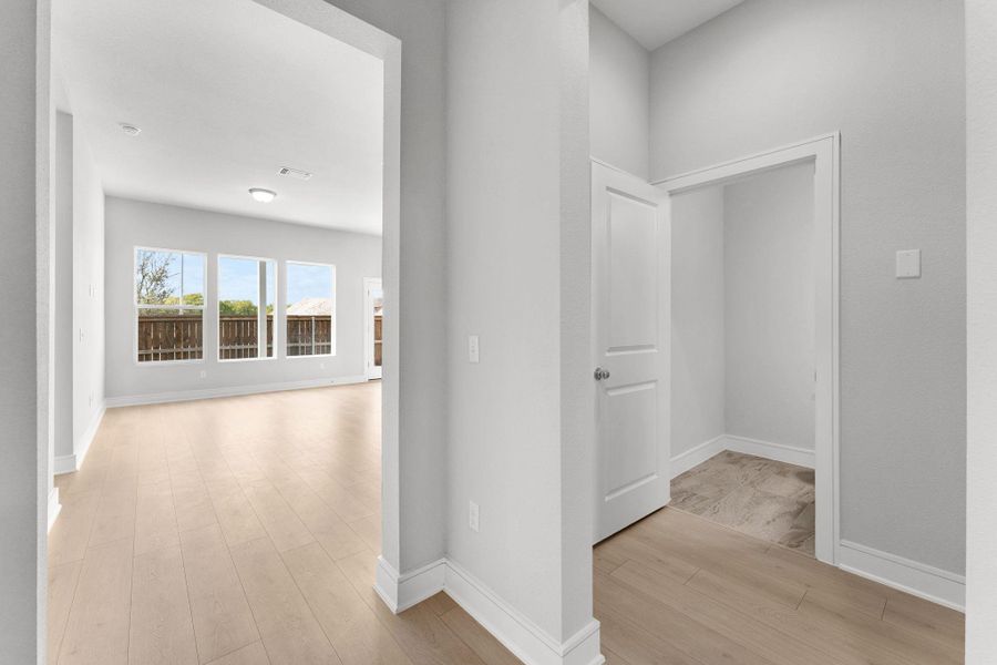 A well-lit living area with generous windows overlooks a private fenced yard. A well-lit living area with generous windows overlooks a private fenced yard.
