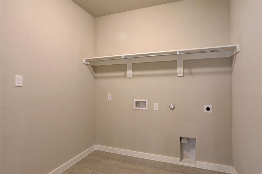 Laundry room featuring hookup for an electric dryer, hookup for a gas dryer, and hookup for a washing machine