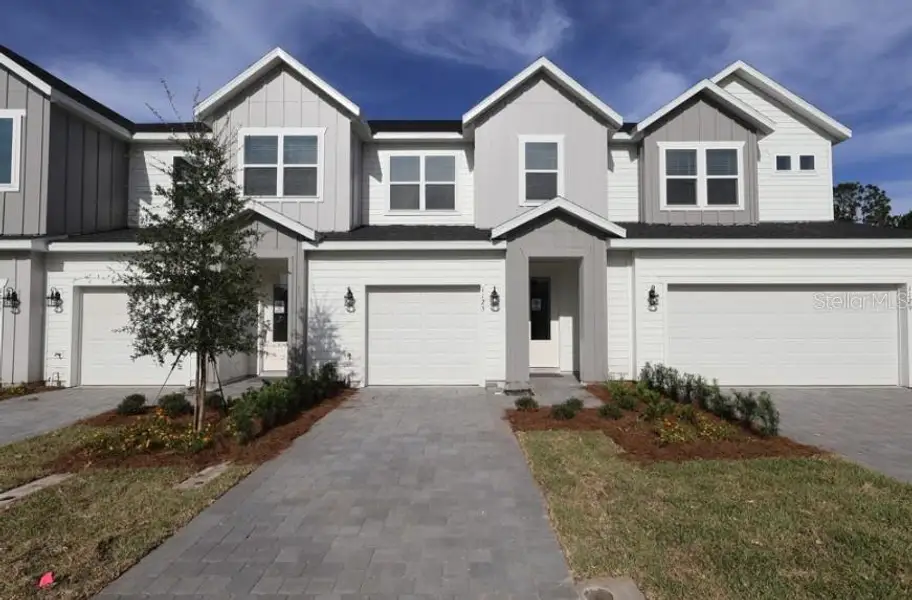 Front exterior of a new home in Preserve at The Cays – The Harbor Series, Daytona Beach, FL, highlighting curb appeal (Image 5).