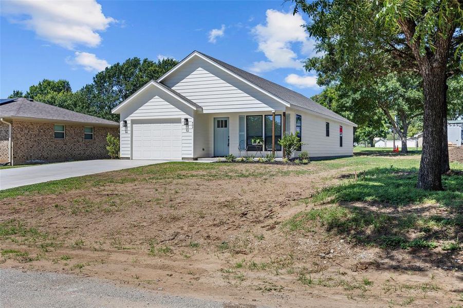 Front exterior of a new home in , Henrietta, TX, highlighting curb appeal (Image 26).