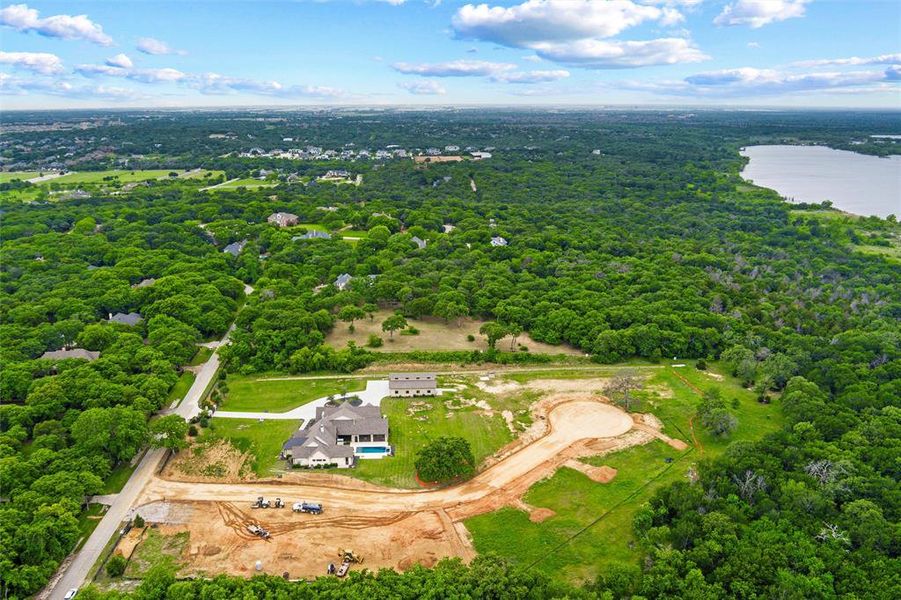 Expansive property featuring a contemporary residence with a private swimming pool, surrounded by mature trees Expansive property featuring a contemporary residence with a private swimming pool, surrounded by mature trees