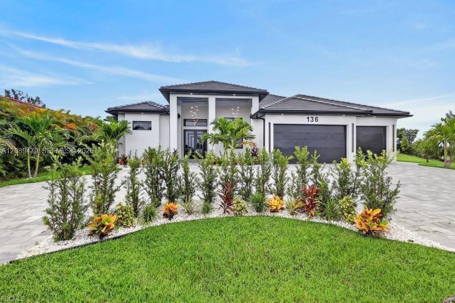 Front exterior of a new home in , Cape Coral, FL, highlighting curb appeal (Image 26). Front exterior of a new home in , Cape Coral, FL, highlighting curb appeal (Image 26).