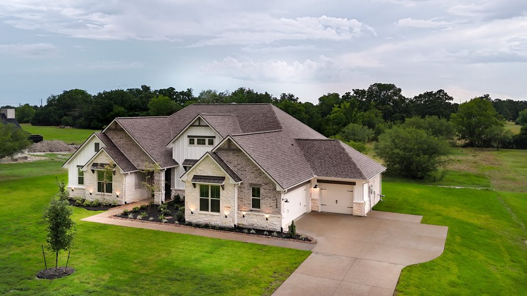 Front exterior of a new home in Windmill Hill, Bryan, TX, highlighting curb appeal (Image 26).