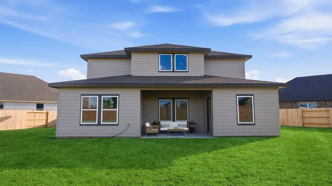 Large fenced-in backyard with a covered patio, perfect for outdoor entertaining. Large fenced-in backyard with a covered patio, perfect for outdoor entertaining.