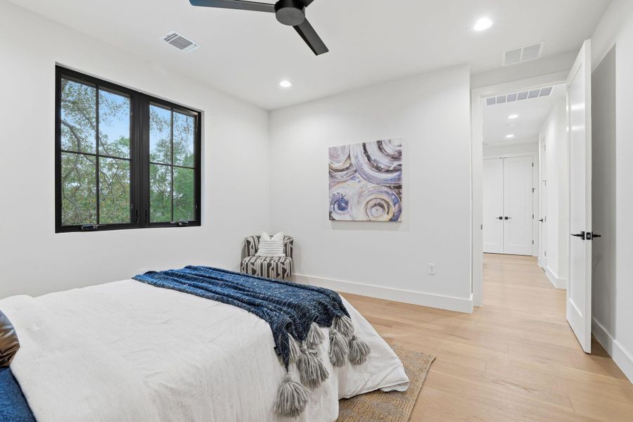 Bedroom featuring light wood-style flooring, a ceiling fan, and recessed lighting