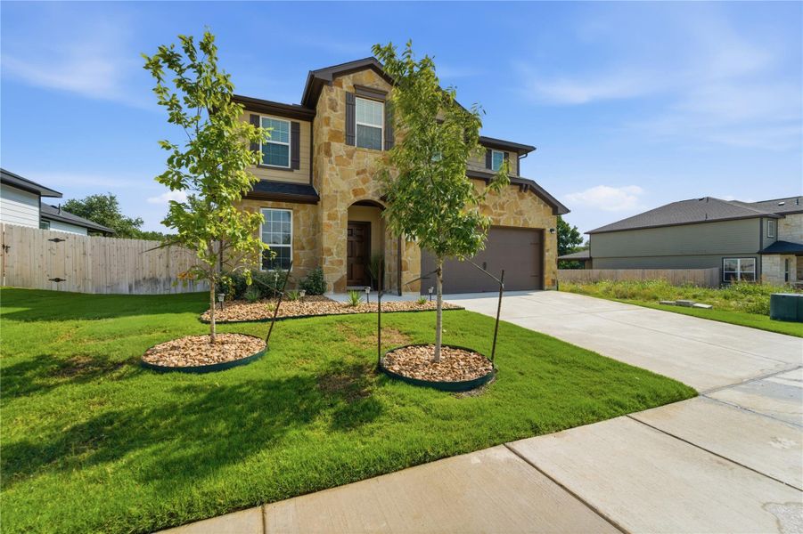 A classic stone facade and inviting arched entry create charming curb appeal for this two-story home. A classic stone facade and inviting arched entry create charming curb appeal for this two-story home.