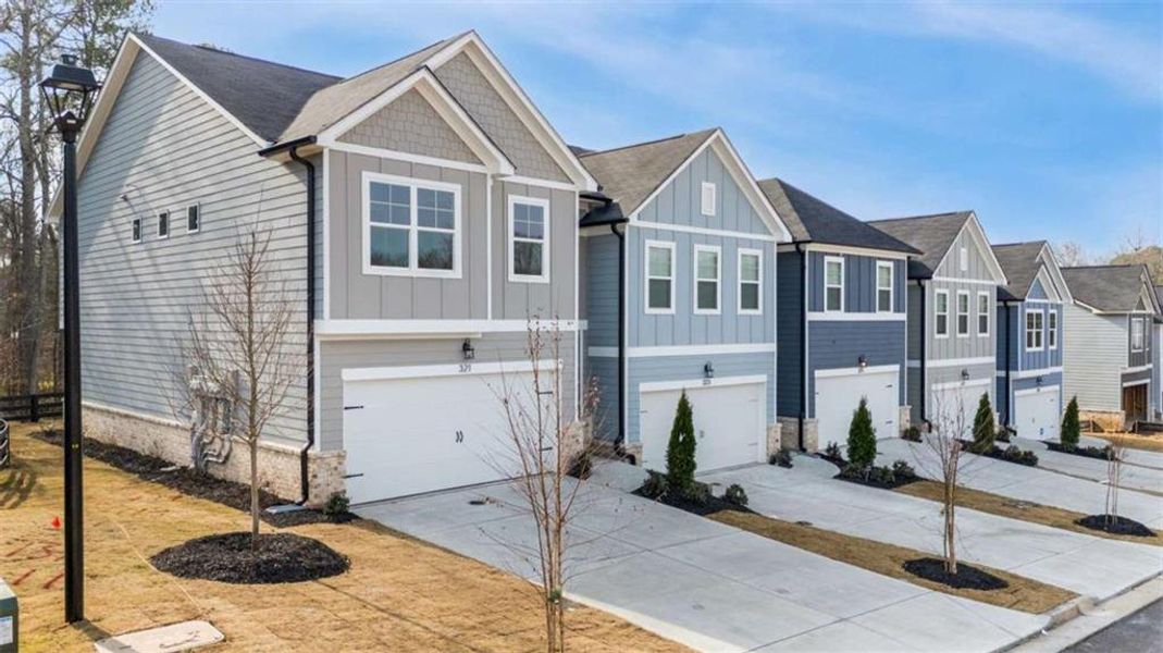 Front exterior of a new home in , Conyers, GA, highlighting curb appeal (Image 2). Front exterior of a new home in , Conyers, GA, highlighting curb appeal (Image 2).