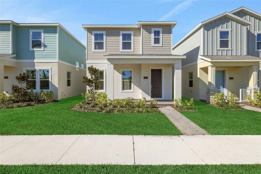 Front exterior of a new home in Serenade at Ovation, Winter Garden, FL, highlighting curb appeal (Image 2). Front exterior of a new home in Serenade at Ovation, Winter Garden, FL, highlighting curb appeal (Image 2).