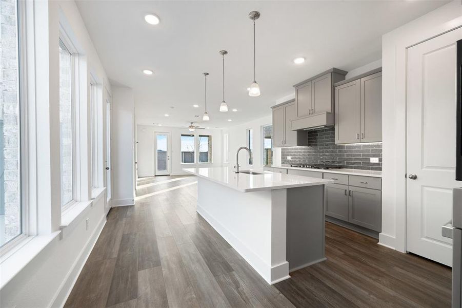 Kitchen featuring gray cabinets, ceiling fan, sink, and dark wood-type flooring