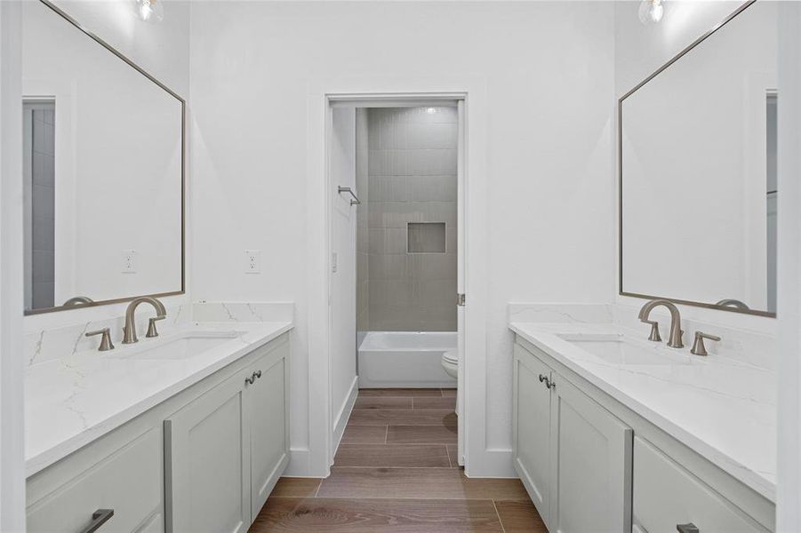 Shared bath has dual vanities with a separate shower area for busy mornings!