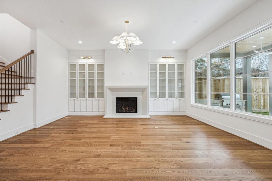 Generous size family Room with Custom Built ins with Glass doors & art lighting! Custom stone fireplace surround! Light and bright with wall of windows overlooking covered Veranda and spacious back yard! Generous size family Room with Custom Built ins with Glass doors & art lighting! Custom stone fireplace surround! Light and bright with wall of windows overlooking covered Veranda and spacious back yard!