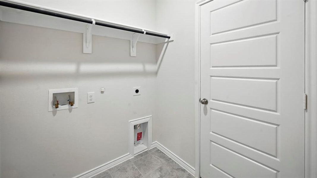 Washroom with gas dryer hookup, hookup for a washing machine, and hookup for an electric dryer