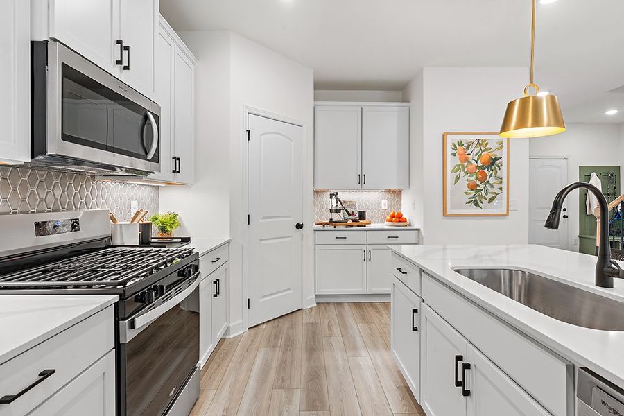 A kitchen with white cabinets. A kitchen with white cabinets.