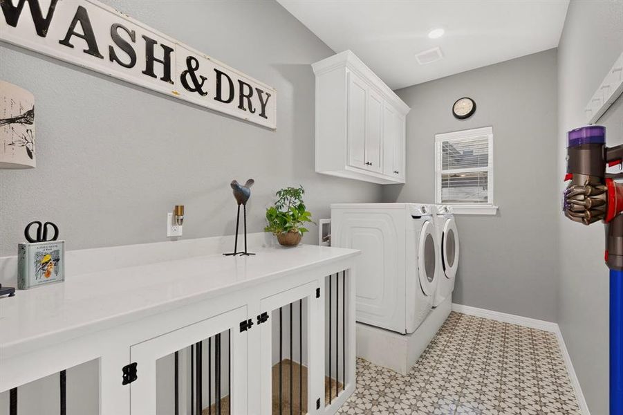 Luxury meets functionality! Large utility with built in cabinets and two large kennels. No pets...no worries! Add cabinet doors and you have instant storage! The quartz countertops make the perfect spot to fold clothes.