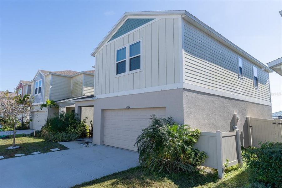 Front exterior of a new home in Pasadena Point, Wesley Chapel, FL, highlighting curb appeal (Image 1). Front exterior of a new home in Pasadena Point, Wesley Chapel, FL, highlighting curb appeal (Image 1).