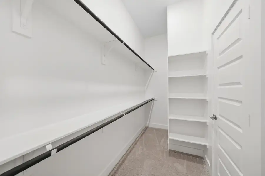Spacious walk in closet with excellent storage and organization potential. Spacious walk in closet with excellent storage and organization potential.