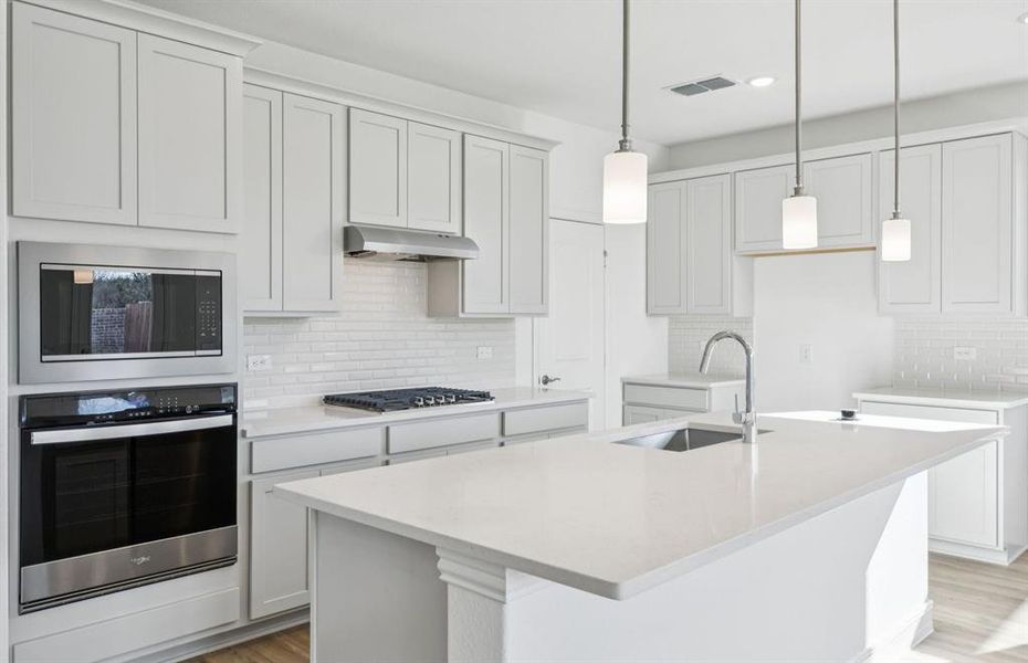 Open island kitchen with stainless steel appliances