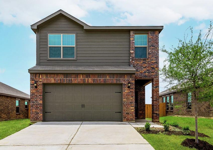 This two-story home has a beautiful brick and siding exterior with a two-car garage.