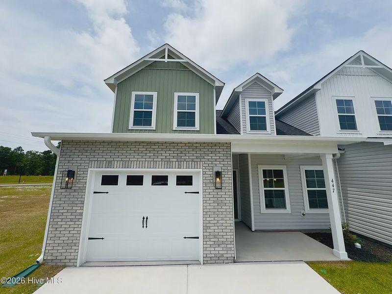 Front exterior of a new home in Autumn Trail, Bolivia, NC, highlighting curb appeal (Image 1). Front exterior of a new home in Autumn Trail, Bolivia, NC, highlighting curb appeal (Image 1).